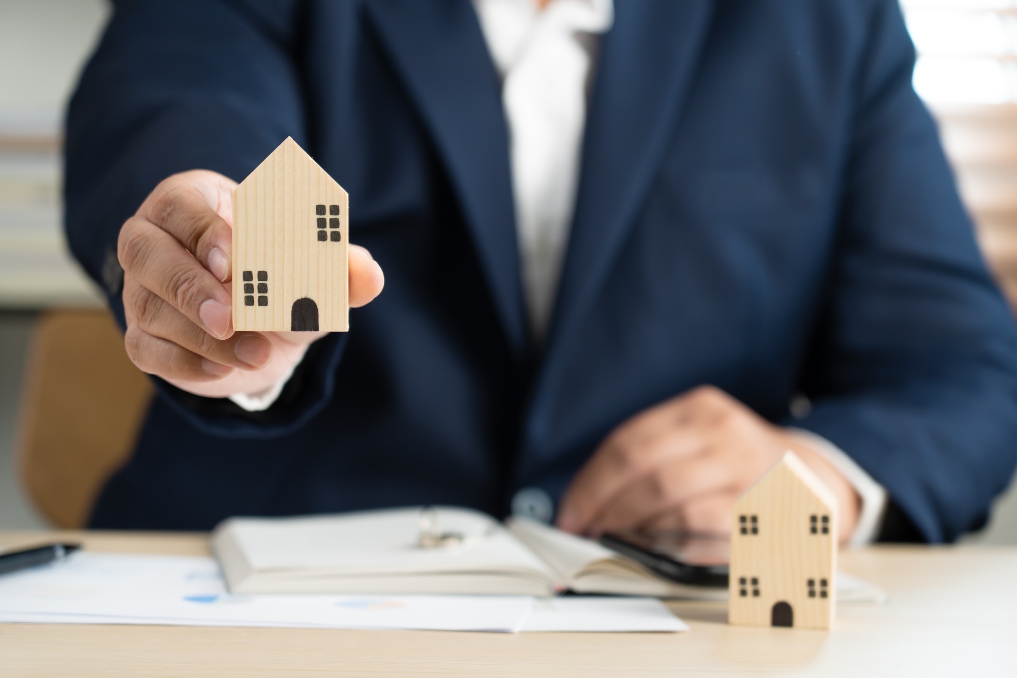 Real estate agent broker or realtor with house and contract plan document paper